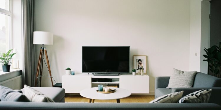 Stylish and modern living room showing perfect television placement on a media console, surrounded by cozy furniture and balanced lighting