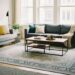 A modern living room showcasing various standard rug sizes like 5x8, 8x10, and 9x12 placed under sofas and tables, illustrating perfect rug placement in home decor
