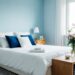 Serene blue bedroom with cozy bedding, stylish furniture, and soft natural lighting, perfect for creating a peaceful and inviting space.