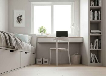 A beautifully organized small bedroom showcasing clever storage solutions, including a bed with built-in drawers, floating shelves, and a narrow vertical bookshelf to maximize space.